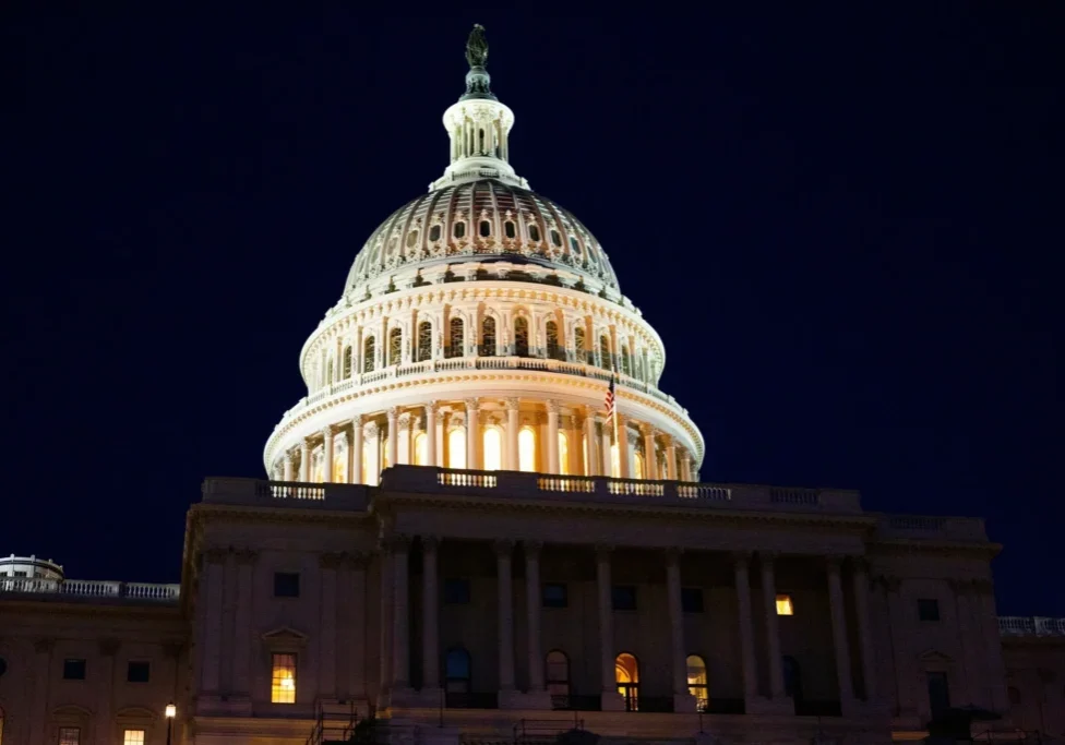 A large building with lights on it's side.